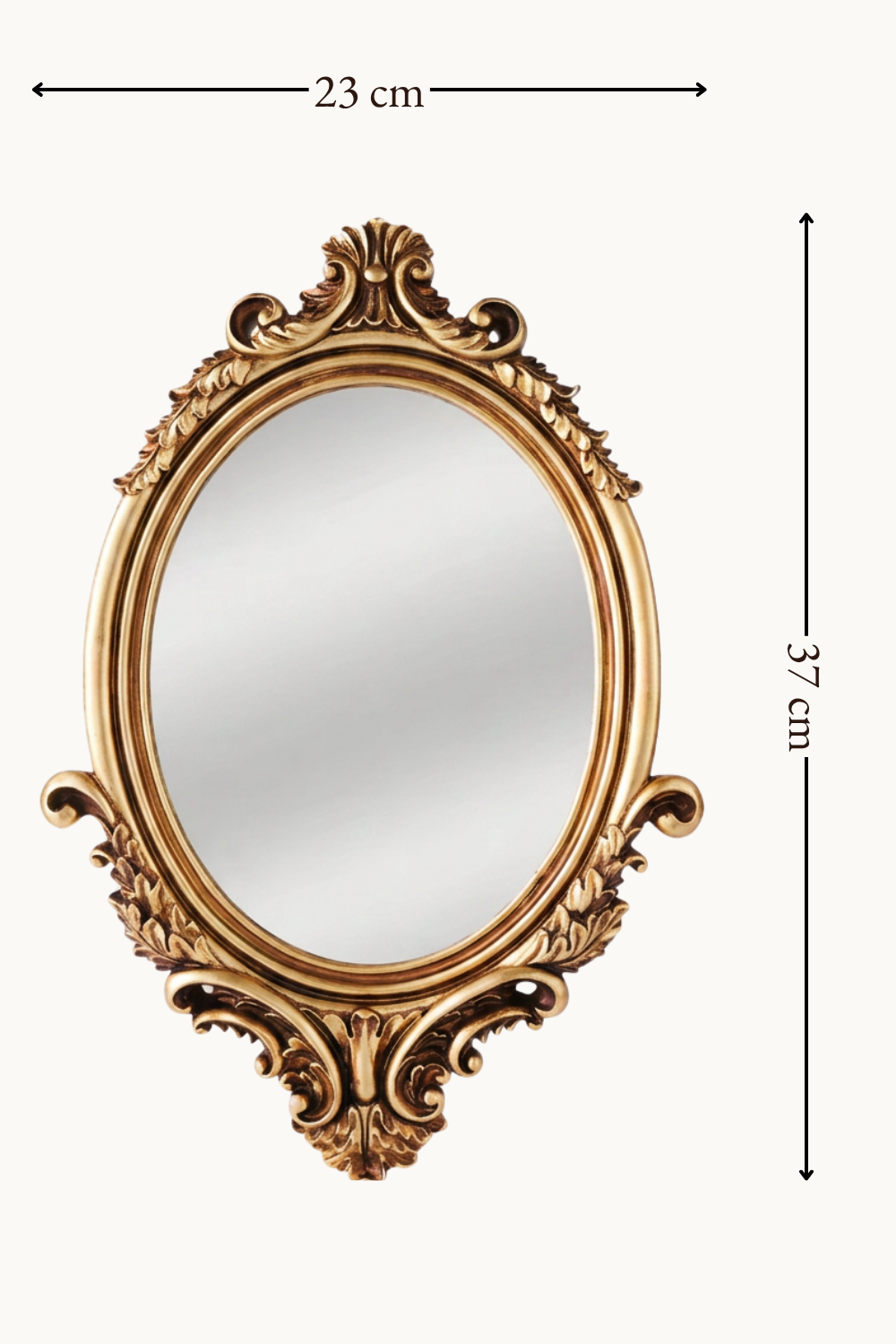 Miroir ovale, baroque doré 37×23 cm, Doré à reliefs sculptés, patine bronze dans les creux. Installé dans un intérieur habité.